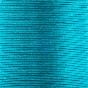 May include: A close-up of a reel of teal blue cord. The cord is tightly wound and has a smooth, slightly shiny finish.