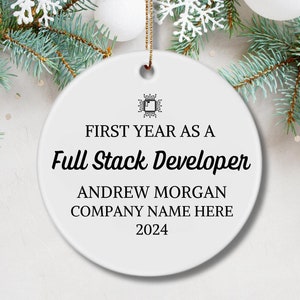 May include: White ceramic Christmas ornament with the text "First Year as a Full Stack Developer" and the name "Andrew Morgan" and "Company Name Here" along with the year "2024".