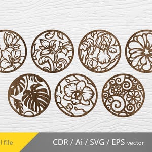 May include: Seven circular wooden cutouts featuring floral and botanical designs. Each cutout showcases a different intricate pattern, including flowers and leaves. The cutouts are in shades of brown and are arranged against a white background. The words "Digital file" are in the bottom left.