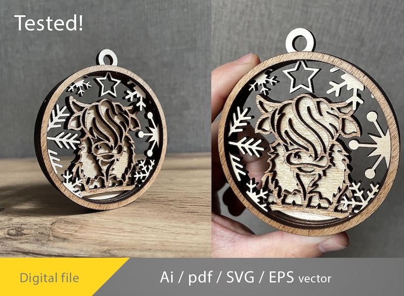 May include: Wooden Christmas ornament featuring a Highland cow design. The ornament is circular with a layered design, showcasing the cow's silhouette, snowflakes, and stars. The text "Tested!" is visible at the top. The ornament is made of light brown wood.