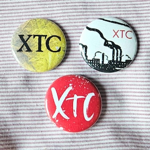 XTC set of three 25mm (1 inch) button pin badges, with original fan art designs.