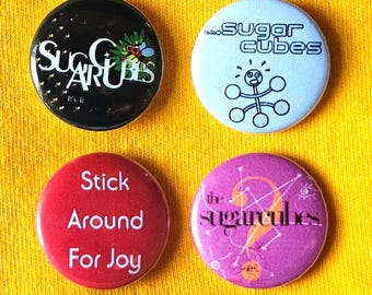 Sugarcubes (Bjork) set of four 25mm (1 inch) button pin badges, featuring colour logo designs, and 'Stick Around For Joy' design.