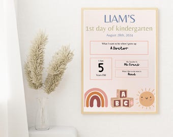 May include: A printable first day of kindergarten sign with a rainbow, blocks, and a sun. The sign includes the child's name, Liam, and the date August 28th, 2024. It also includes information about the child's age, teacher, and favorite activity.