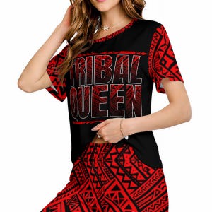 May include: Black and red two-piece outfit with a tribal pattern. The top features the text "TRIBAL QUEEN" in white, outlined in red. The sleeves and shorts have a repeating geometric design.