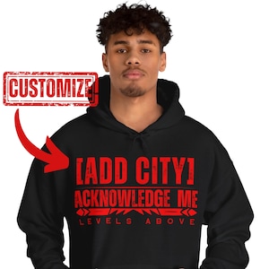May include: Black hooded sweatshirt with red text that reads "[ADD CITY] ACKNOWLEDGE ME LEVELS ABOVE".