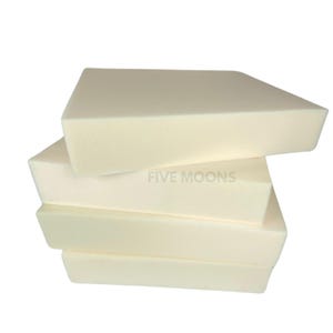 May include: Four rectangular pieces of white foam stacked on top of each other. The top piece has the words "FIVE MOONS" printed on it.