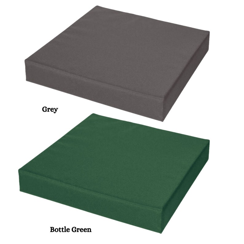 May include: Two square seat cushions, one grey and one bottle green. The cushions are made of a soft, textured fabric.