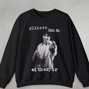 May include: Black sweatshirt with a white print of Elliott Smith giving the middle finger. The text "either/or" is printed below the image.