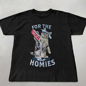 May include: Black t-shirt with a graphic of a cat wearing a bandana pouring milk from a carton that says "Milk" and the text "For the Homies".