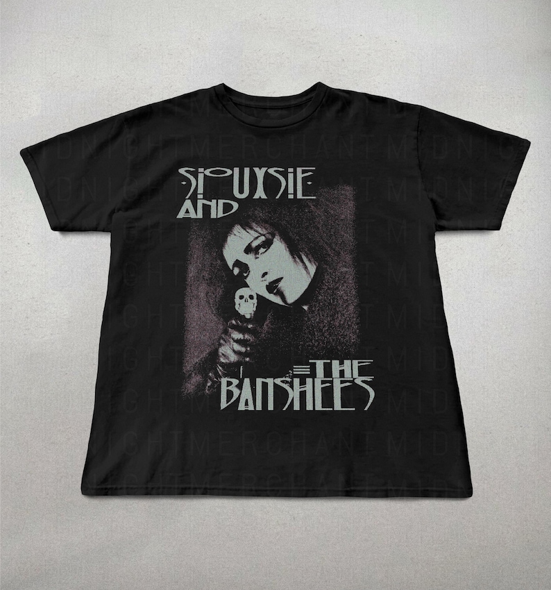 May include: Black t-shirt featuring a grayscale image of Siouxsie Sioux holding a skull, with the band name "Siouxsie and the Banshees" printed in white. The shirt has a crew neck and short sleeves.