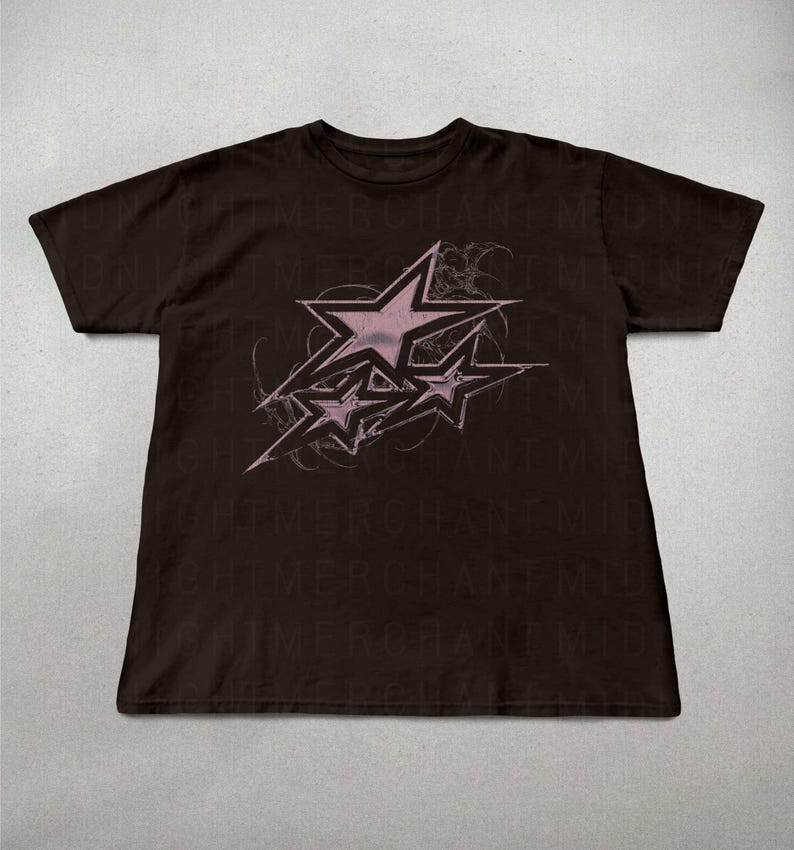 May include: Black t-shirt with a pink graphic of three stars with a swirling design. The text "NIGHTMERCHANT" is repeated in a faded print on the shirt.