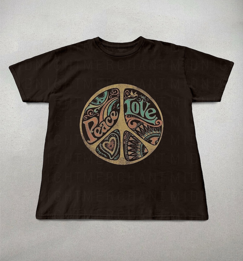 May include: A brown t-shirt with a peace sign graphic. The peace sign is filled with a colorful design and the words "Peace" and "Love" are written inside the symbol.
