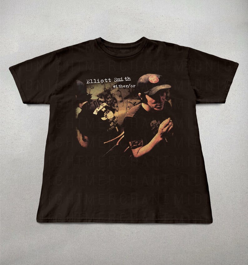 May include: A dark brown t-shirt with a graphic of a person wearing a cap, and the text "Elliott Smith either/or" in white. The image has a vintage, slightly faded appearance, suggesting a retro or music-related theme.