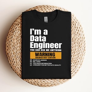 May include: Black t-shirt with white text that reads "I'm a Data Engineer You Can Ask Me Anything Warning Answer May Contain: Complex Jargon SQL Joins Too Much Information A Request For Better Data Quality"