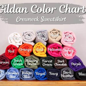 May include: A color chart for Gildan crewneck sweatshirts. The image displays rolled-up sweatshirts in various colors, including white, ash, sport gray, sand, light pink, red, orange, gold, and more. The text "Gildan Color Chart Crewneck Sweatshirt" is at the top.