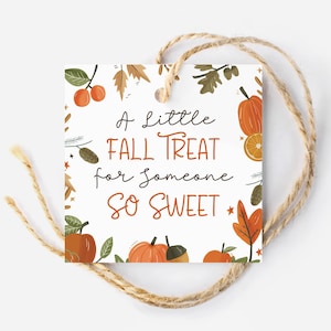 May include: A white gift tag with autumn-themed illustrations of pumpkins, leaves, and acorns. The text reads "A little fall treat for someone so sweet."