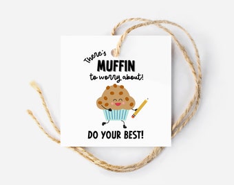 May include: A white gift tag with a brown and blue cartoon muffin holding a pencil. The text on the tag reads "There's muffin to worry about! Do your best!"
