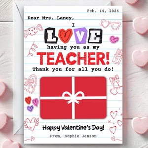 May include: A Valentine's Day card with a red gift box illustration and the message "I LOVE having you as my TEACHER!" on lined paper. The card is decorated with hearts and candy drawings. The card is signed "From, Sophie Jenson."