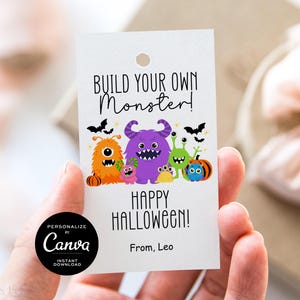 May include: A white tag with the text "BUILD YOUR OWN Monster!" and "HAPPY HALLOWEEN!" features colorful monster illustrations. The tag includes a black circle with the Canva logo and the text "PERSONALIZE BY Canva INSTANT DOWNLOAD".