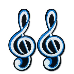 May include: Two embroidered treble clef patches. Each patch has a black background with a white and blue treble clef design. Ideal for musical instrument accessories or clothing.