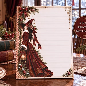 May include: A 7 page printable notepad set featuring a lined sheet with a decorative border. The design includes a woman in a long red velvet dress and a matching witch hat, holding a lantern, surrounded by pine branches, berries, and gold stars.