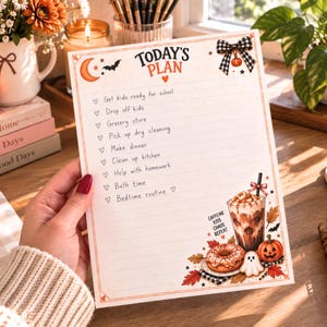 May include: A white paper planner sheet titled Today's Plan with a list of daily tasks marked by heart icons. The design features autumn-themed illustrations including a pumpkin, a ghost, a coffee drink, and fall leaves, with the text Caffeine Kids Chaos Repeat.
