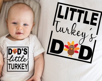 May include: A white t-shirt with the text "Little Turkey's Dad" in a black box with a cartoon turkey inside. A white onesie with the text "Dad's little Turkey" in a black box with a cartoon turkey inside.