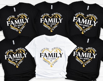 May include: Several black and white t-shirts featuring a heart-shaped design with the word "FAMILY" in the centre. The text around the heart reads "Side by Side or Miles Apart, Will Always Be Connected by Heart."