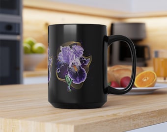 May include: Black ceramic mug with a purple and gold iris flower design. The mug has a white interior and a black handle.
