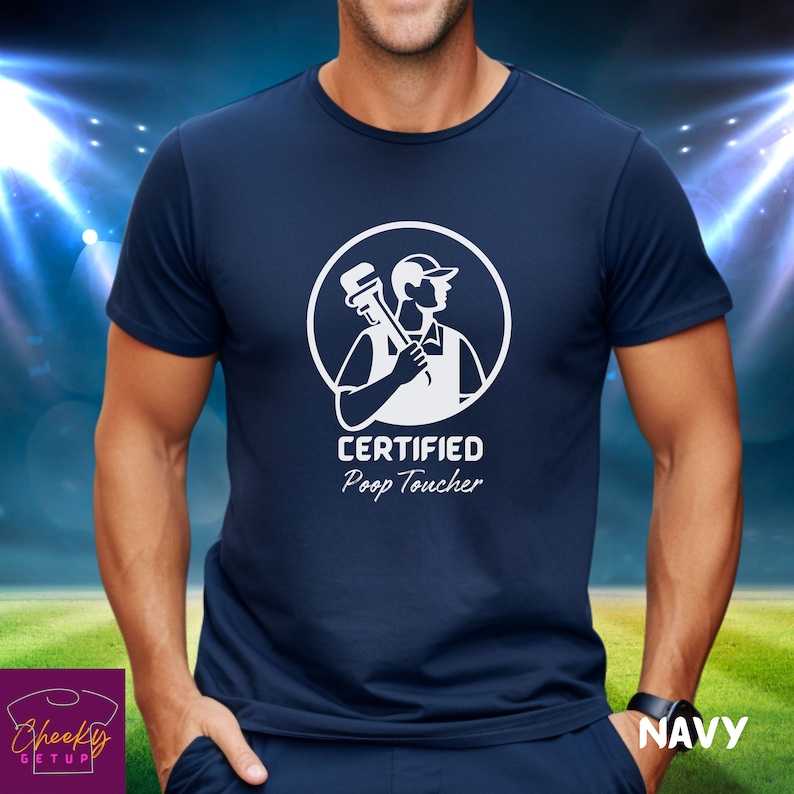 May include: A navy blue t-shirt with a white graphic of a plumber holding a wrench. The graphic is inside a circle with the text "CERTIFIED Poop Toucher".