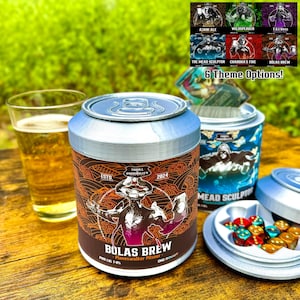 May include: A silver can with a colorful label featuring a fantasy creature and the text "Bolas Brew - Planeswalker Pilsner". The can is open and has dice inside. The can is sitting on a wooden table with a glass of beer in the background.