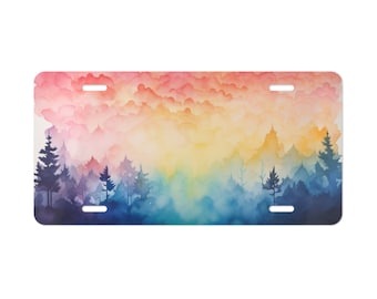 Puede incluir: Una pintura de acuarela de una escena de bosque con un cielo colorido. El cielo es un degradado de rosa, naranja, amarillo y azul. Los árboles están silueteados contra el cielo.