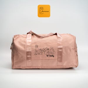 a pink duffel bag with a picture of a dog on it
