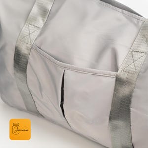 a large gray bag sitting on top of a white table