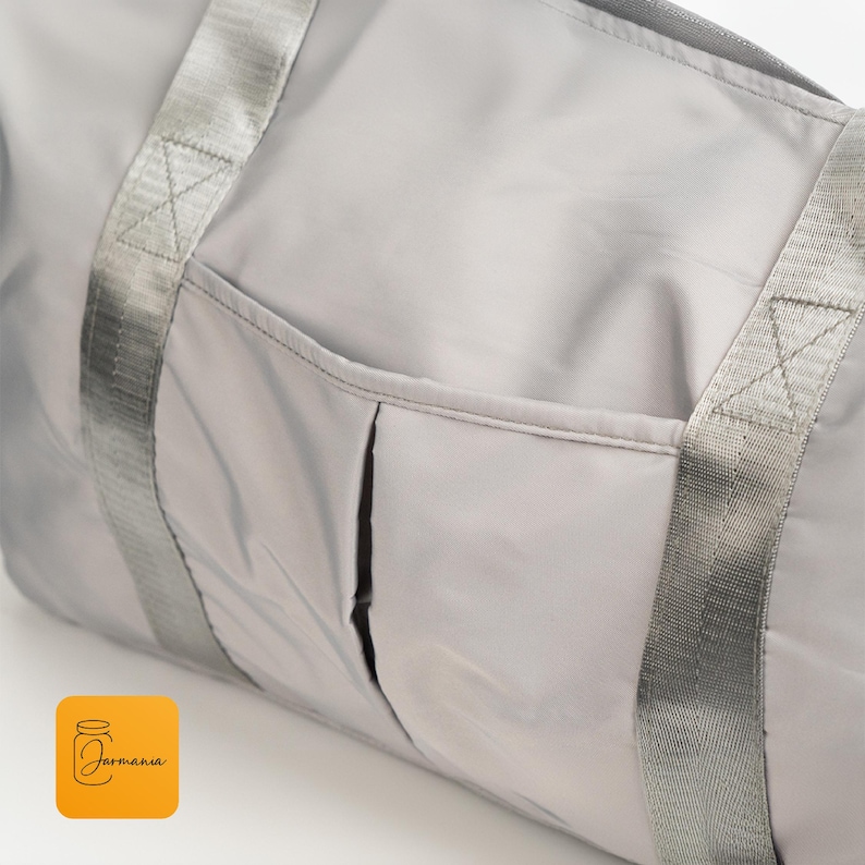 a large gray bag sitting on top of a white table