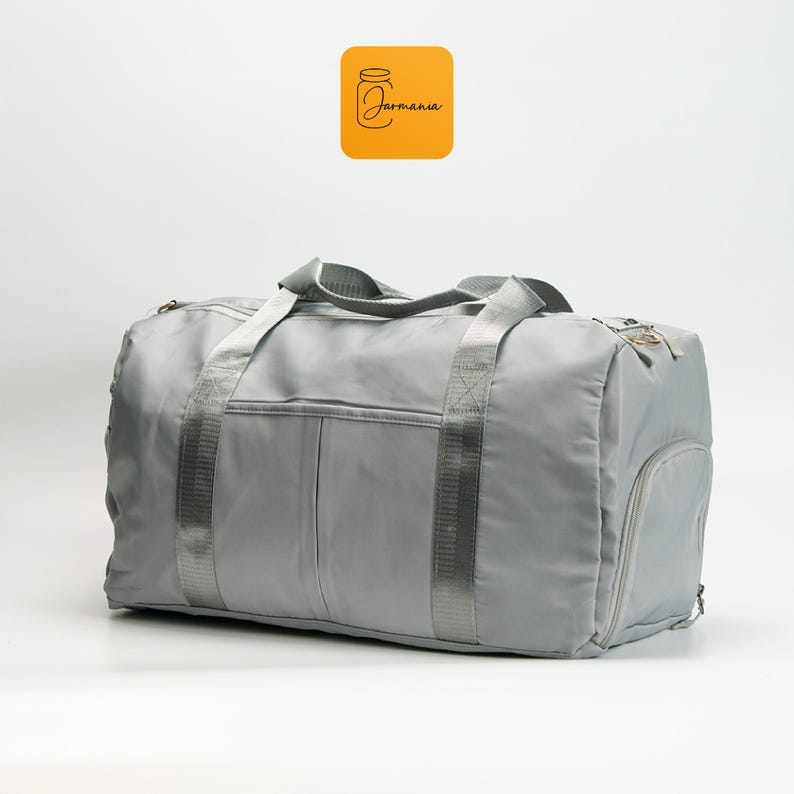 a gray duffel bag sitting on top of a white floor