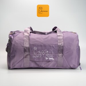 a purple duffel bag sitting on top of a white floor