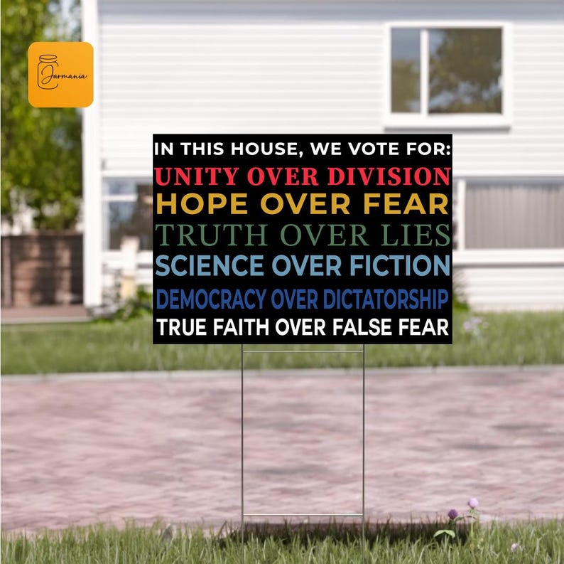 a sign in front of a house that says, in this house we vote for
