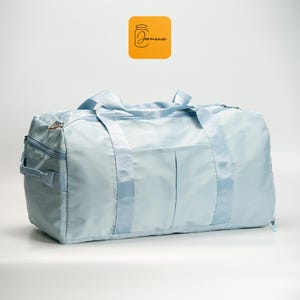 a blue duffel bag sitting on top of a white floor