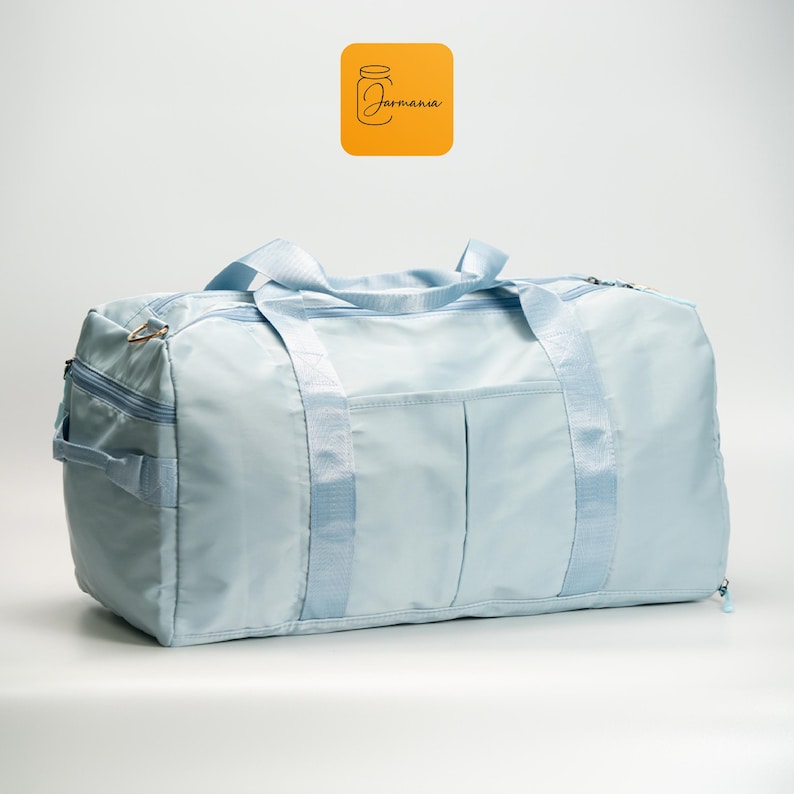 a blue duffel bag sitting on top of a white floor