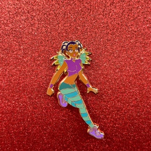 May include: A gold-colored enamel pin featuring a cartoon character with purple and green clothing, brown hair, and glasses. The character is running and has wings.