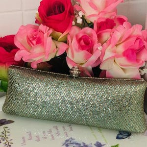 Elegant Metallic Clutch with a textured shimmery finish perfect for evening wear or special events, adding  touch of sparkle to any outfit.