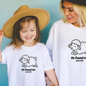 May include: A white t-shirt with a black and white illustration of a sheep and the text "He found me Luke 15:4".