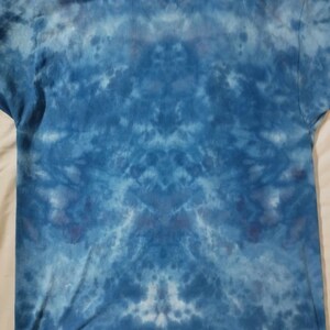 May include: A blue tie-dye t-shirt with a faded, abstract pattern.