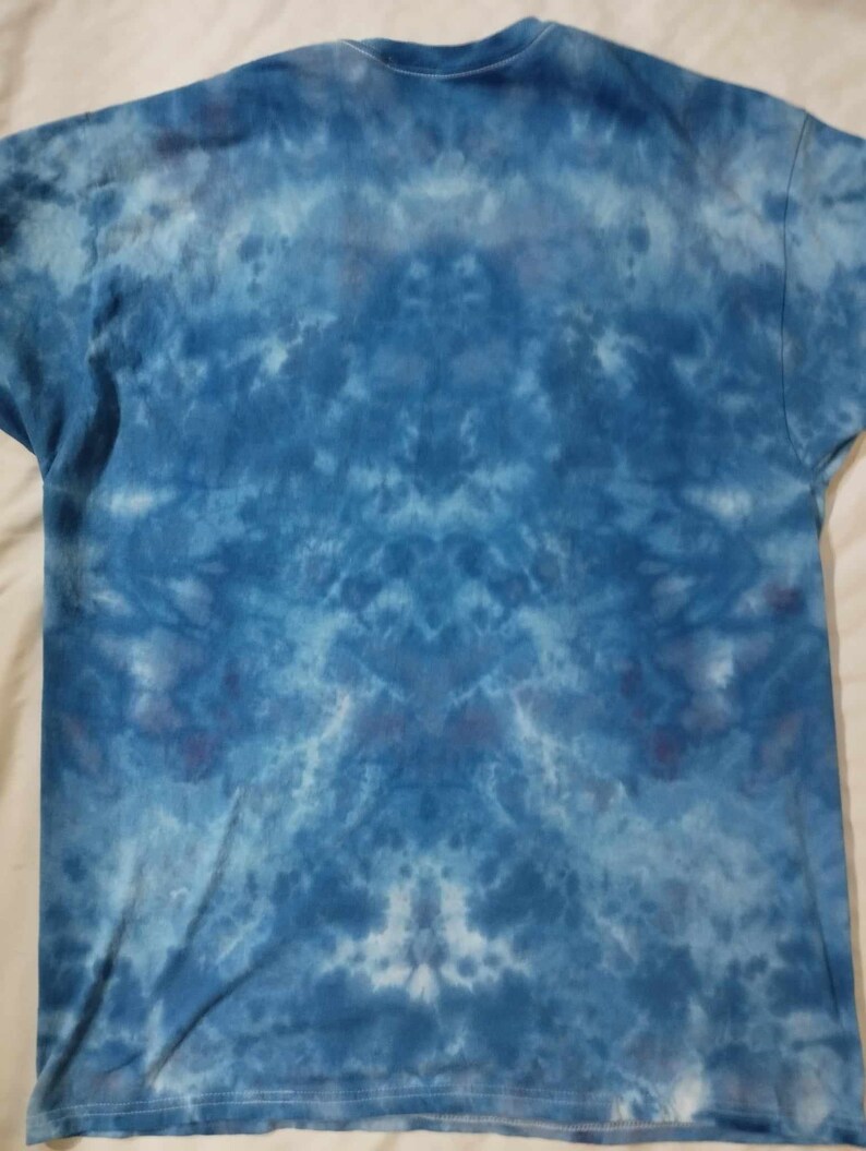 May include: A blue tie-dye t-shirt with a faded, abstract pattern.