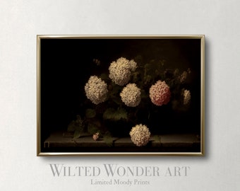 May include: A framed art print featuring a still life of white and pink hydrangea blooms in a dark vase. The artwork has a vintage aesthetic with the text "Wilted Wonder Art" and "Limited Moody Prints" at the bottom.
