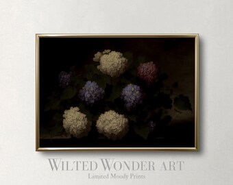 May include: A framed art print featuring a vintage-style floral arrangement. The artwork showcases clusters of white, purple, and pink hydrangeas against a dark background. The frame is gold, and the text "Wilted Wonder Art" and "Limited Moody Prints" are visible.