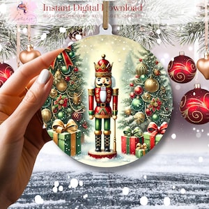 May include: A round Christmas ornament featuring a Nutcracker standing between two decorated Christmas trees. The Nutcracker is wearing a red and green uniform with a gold crown. The trees are adorned with red and gold ornaments, green garlands, and red bows.