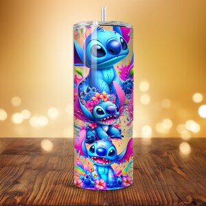 May include: A tall, stainless steel tumbler featuring a vibrant, colorful design of the character Stitch from the animated film Lilo & Stitch. The design includes multiple images of Stitch with floral accents, set against a bright, abstract background. The tumbler has a straw.