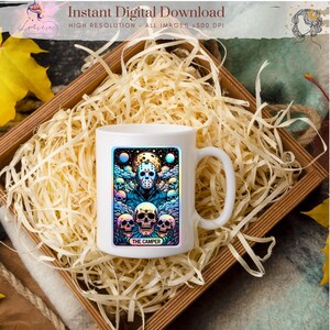 May include: White ceramic mug featuring a colorful graphic of a masked figure surrounded by skulls, with the text "THE CAMPER." The mug is set in a wooden box filled with wood shavings. The image also includes the text "Instant Digital Download" and "High Resolution - All Images >300 DPI."